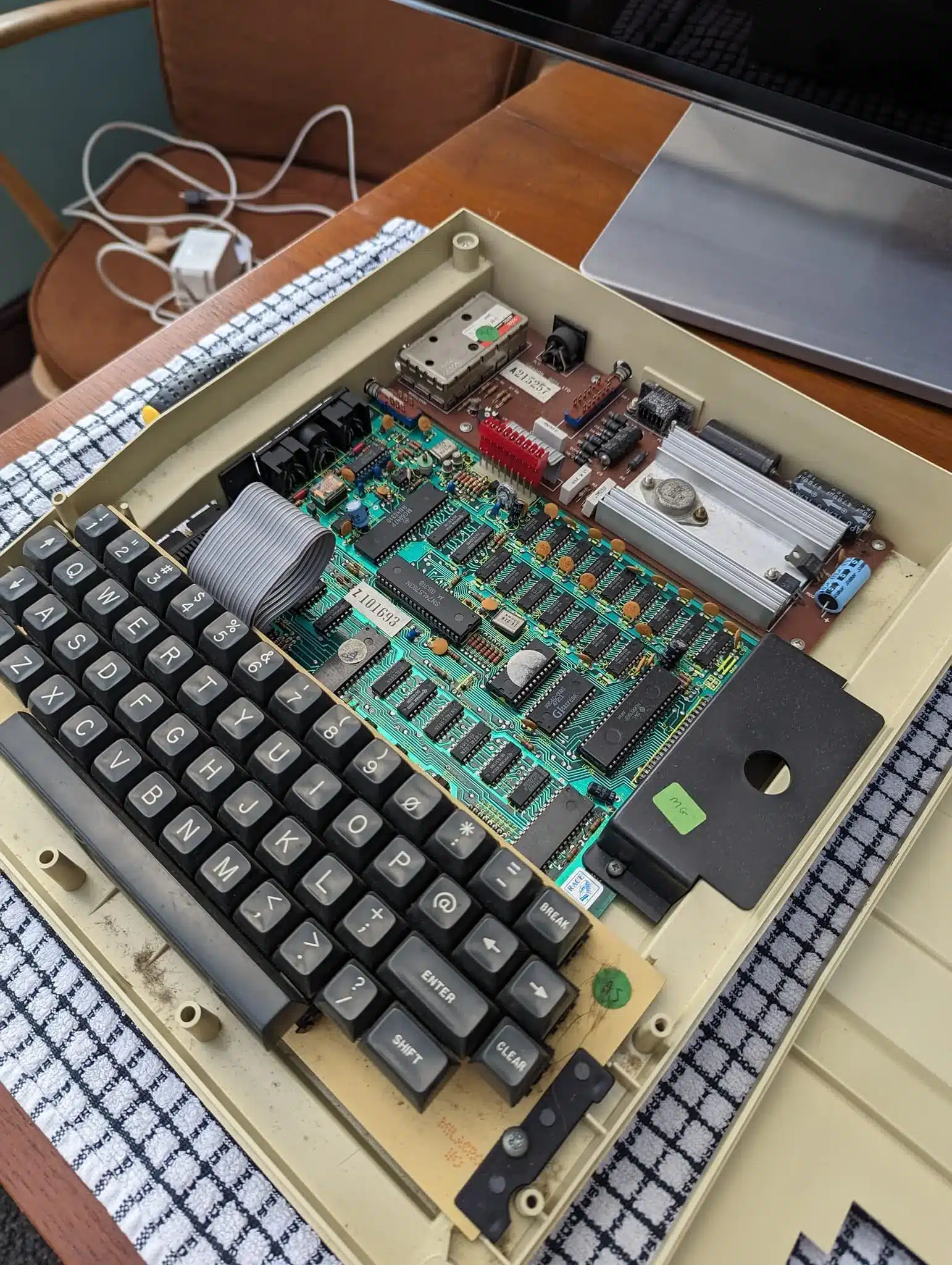 The interior of a Dragon 32, showing its motherboard with the Motorola 6809E and support chips, and the keyboard assembly