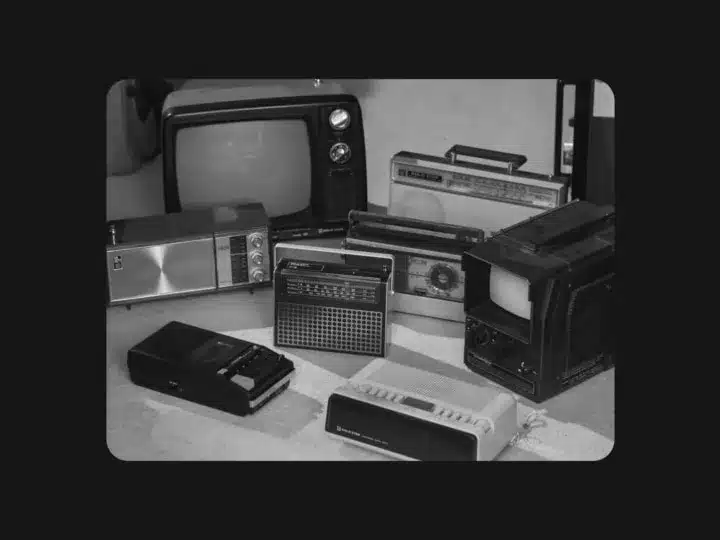 Black and white photo of 1970s-80s Goldstar radios, portable televisions and cassette players