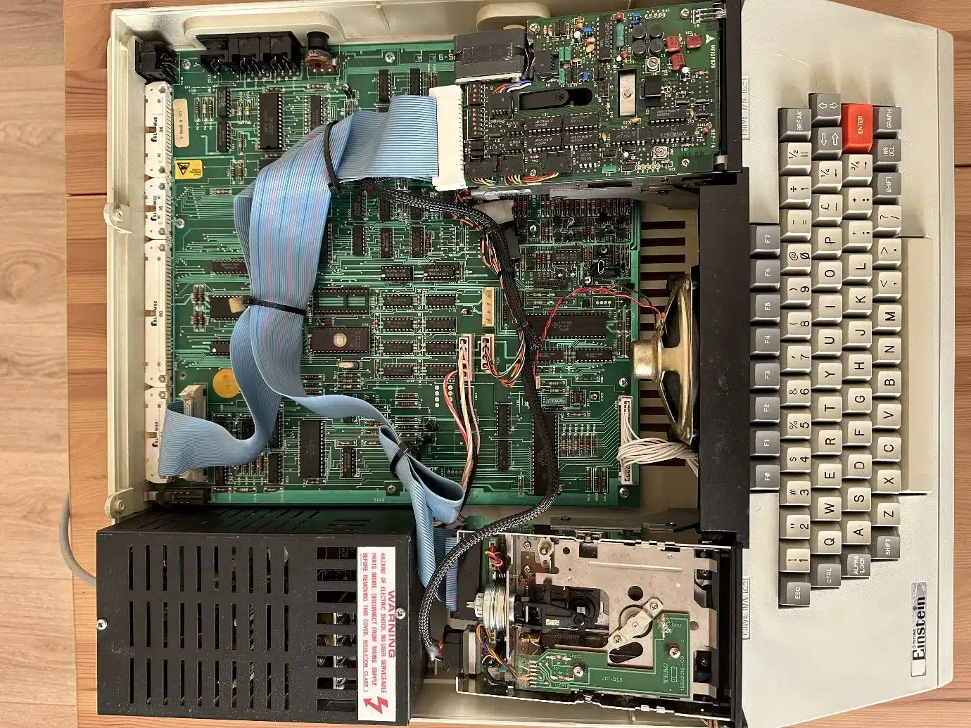 Tatung Einstein with the case lid off, showing the main board, ribbon cables, power supply and disk drive