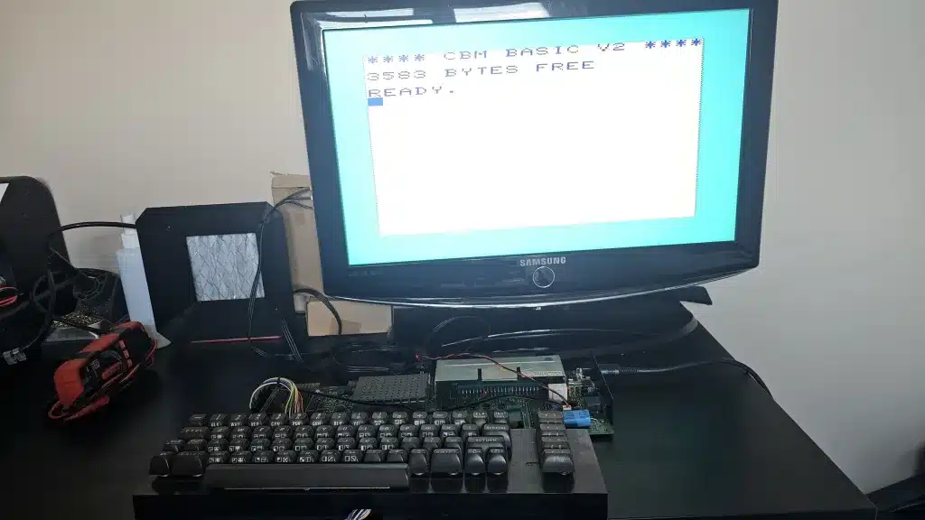 The bare board running on the spare C64 power supply, with the keyboard still connected