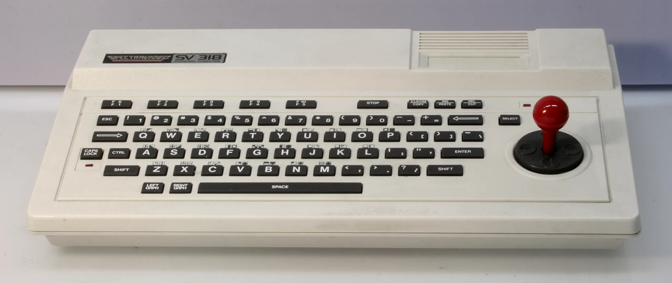 Spectravideo SVI-318 home computer with its Chiclet keyboard and red joystick
