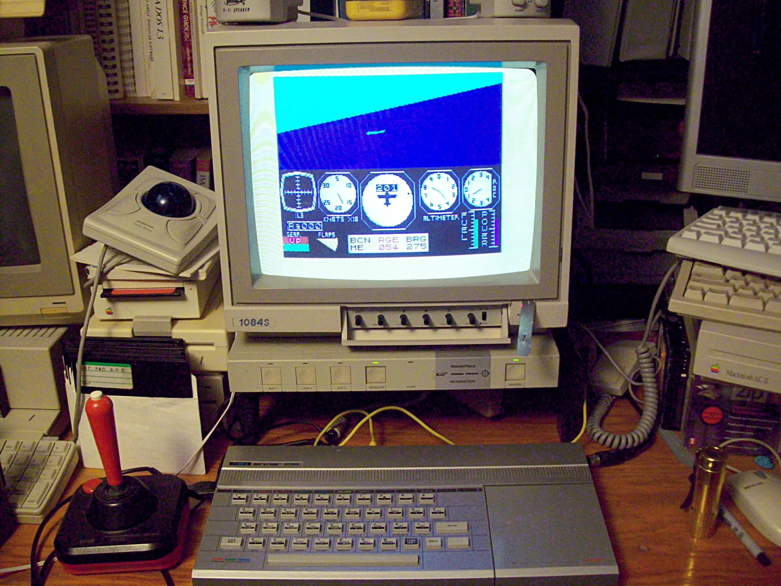 Timex Sinclair 2068 connected to a CRT monitor running a flight simulator game, with a joystick and trackball