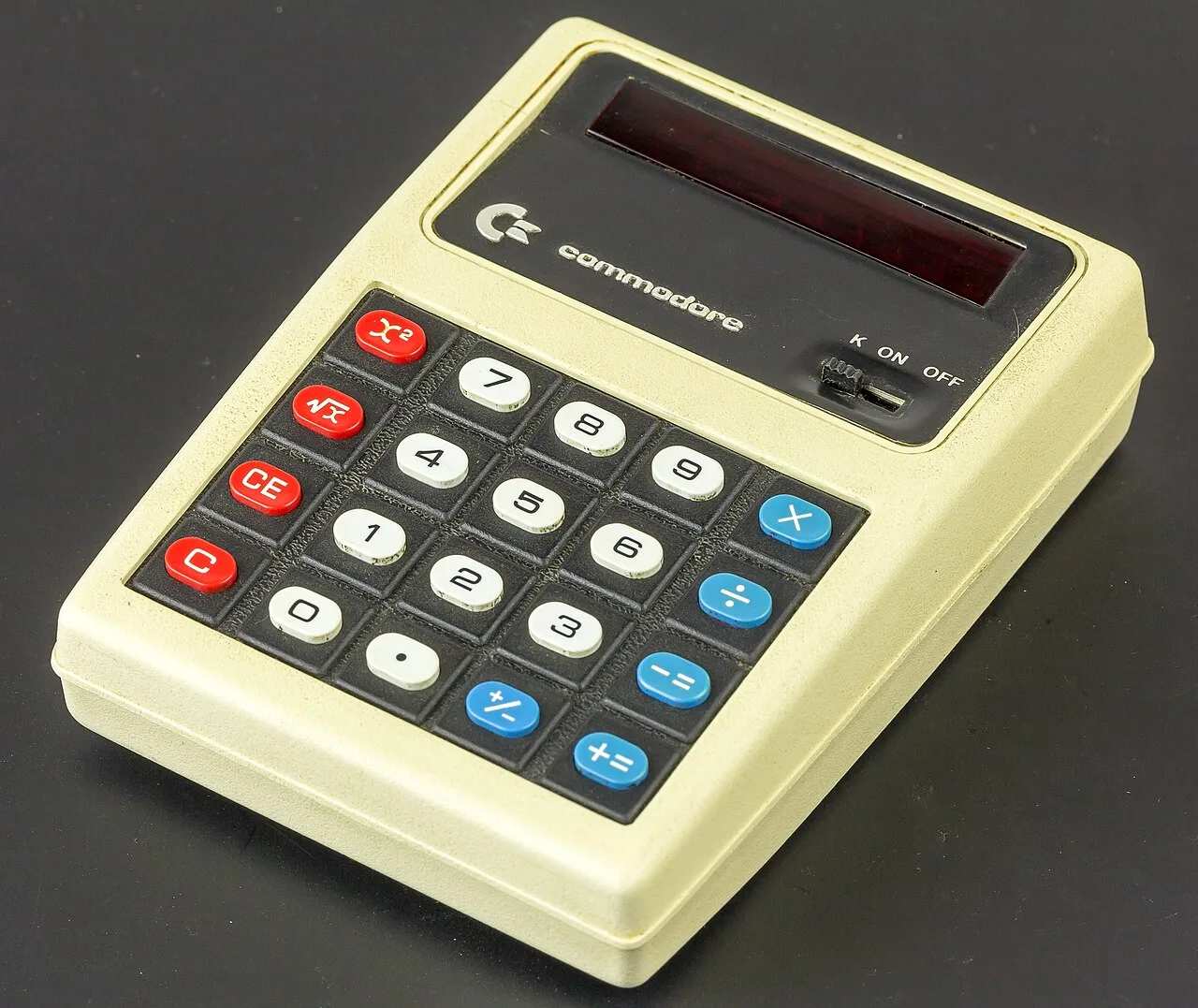 A Commodore pocket calculator with a red LED display and rubber keys